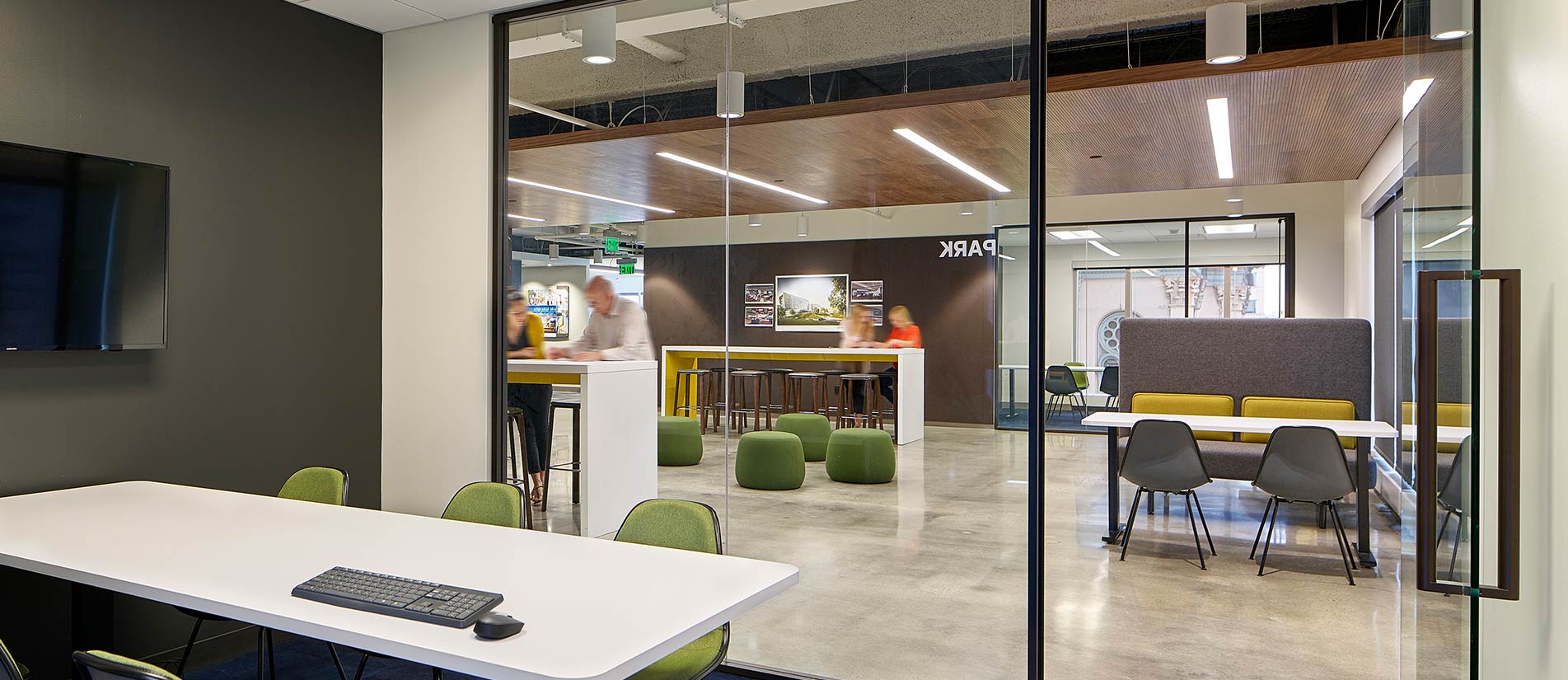 Multiple workspaces in an open floor plan are divided by One-LP movable partitions and glass walls.